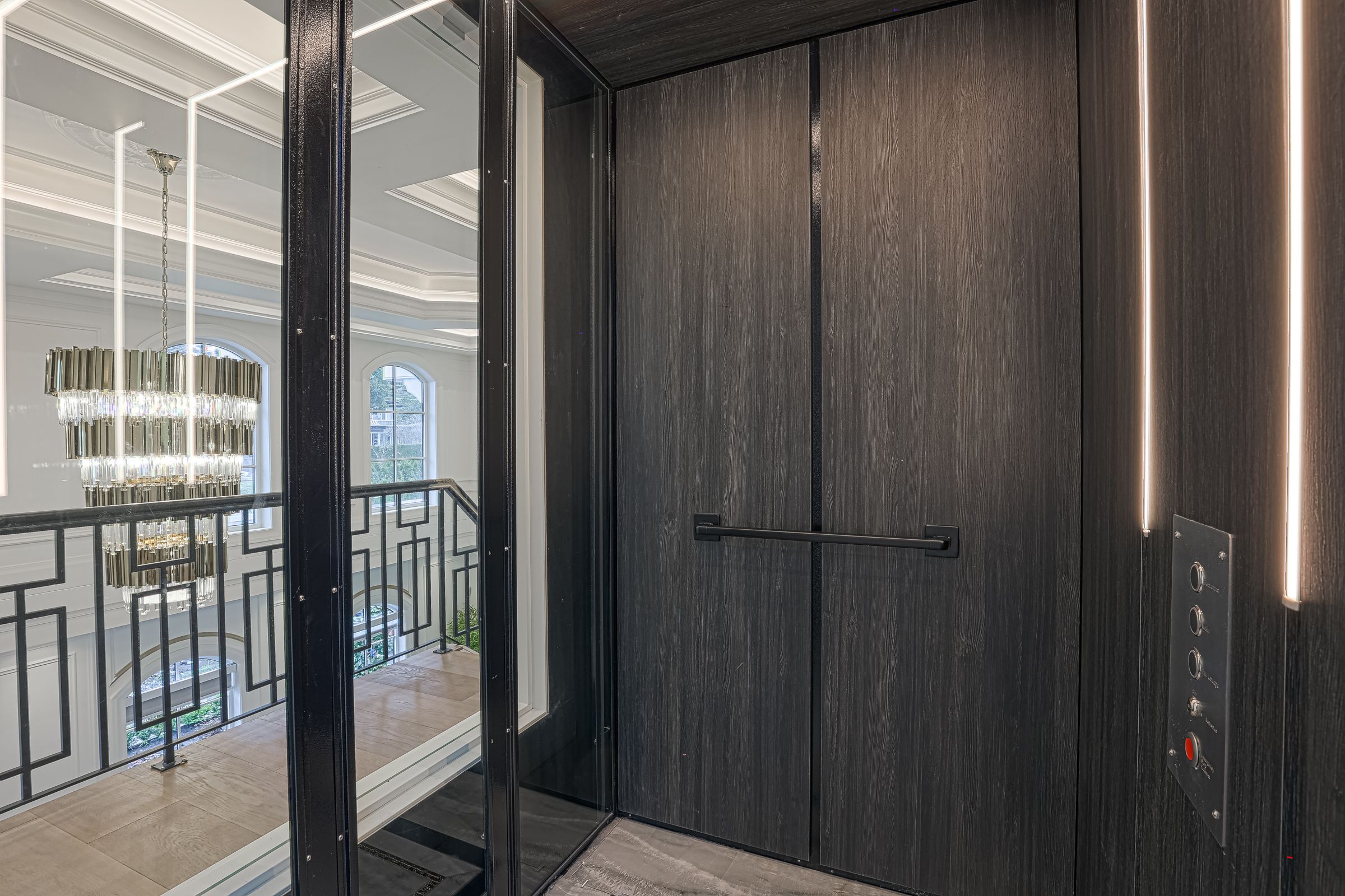 A door way with two doors and a metal handle.