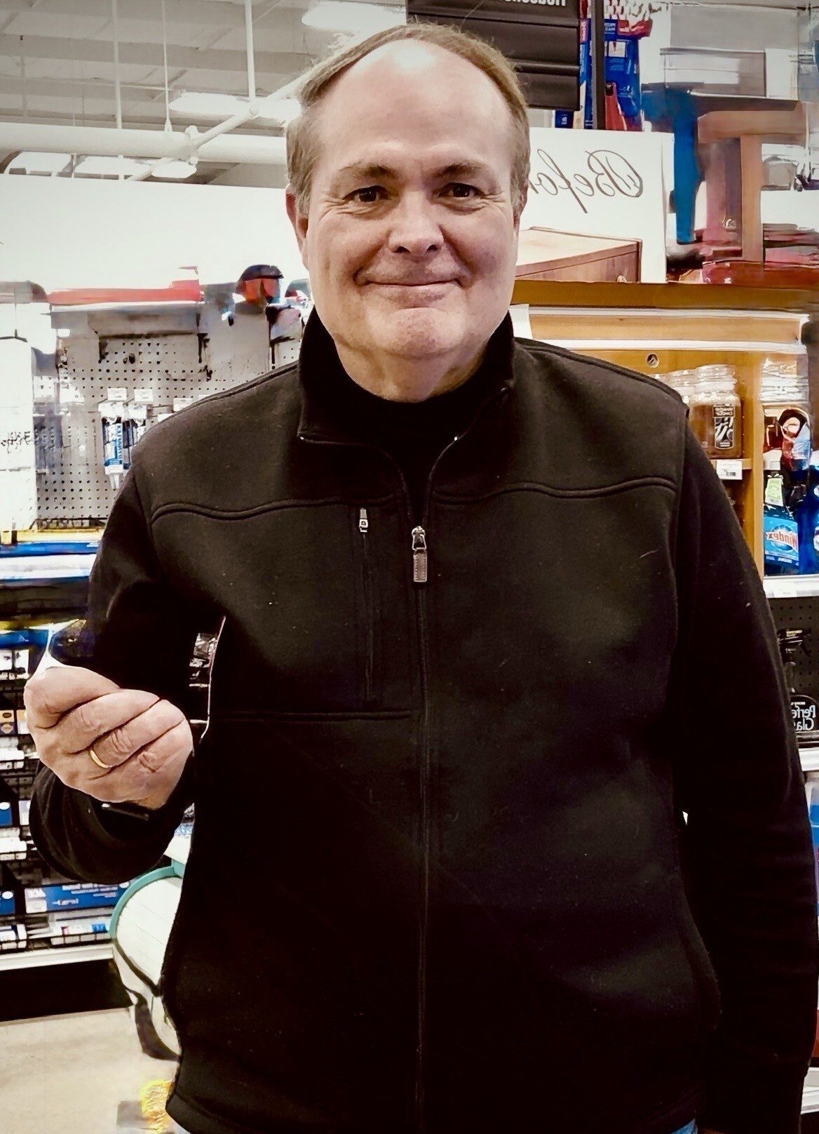A man holding a key in his hand.