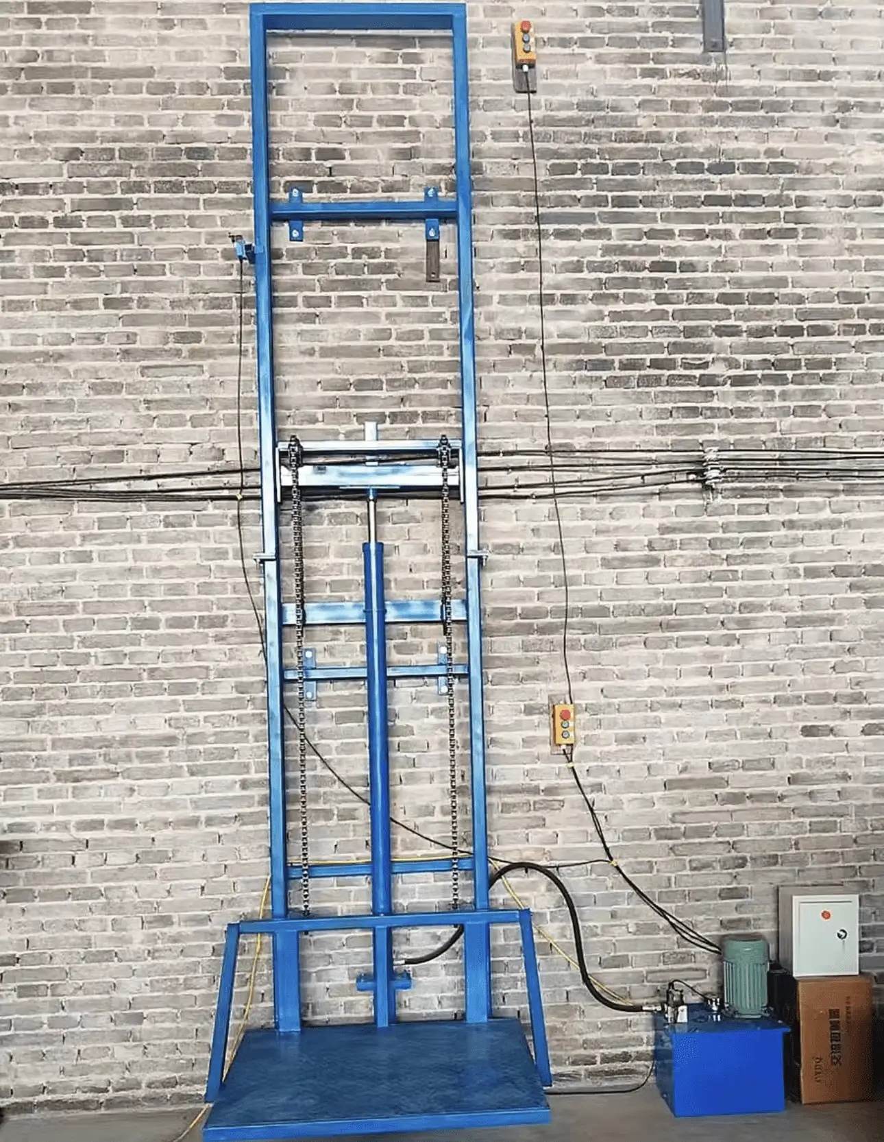 A blue ladder leaning up against the side of a brick wall.